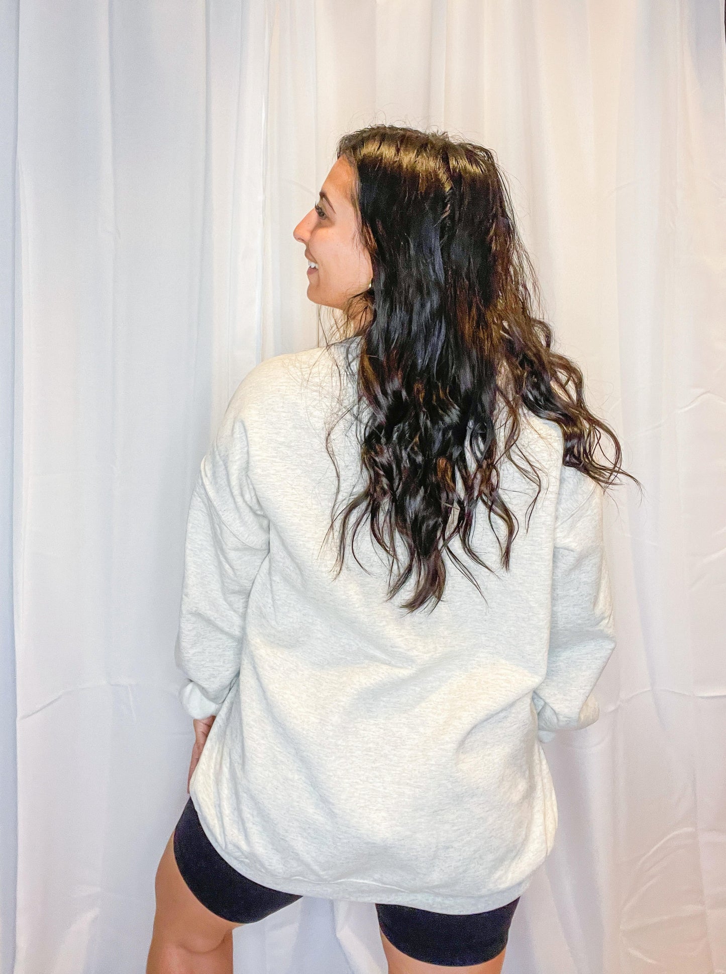 A soft and comfy light grey crewneck sweatshirt with God is Good embroidered on the front.