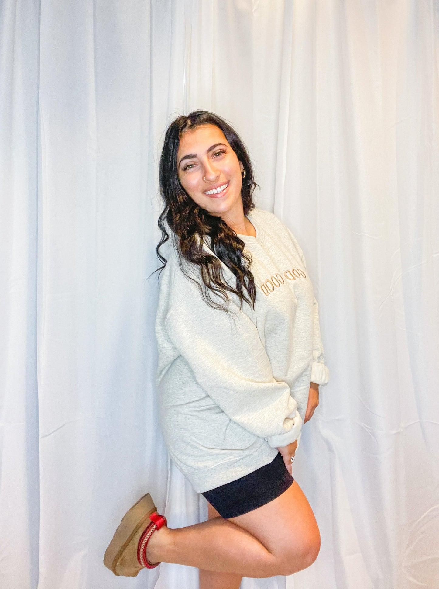 A soft and comfy light grey crewneck sweatshirt with God is Good embroidered on the front.
