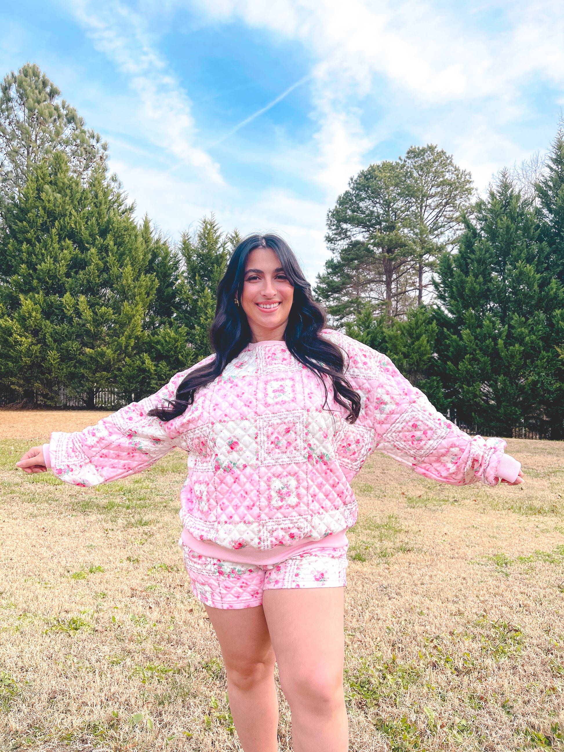 Cozy pink floral quilted loungewear set featuring a long-sleeve top and shorts, perfect for casual wear.