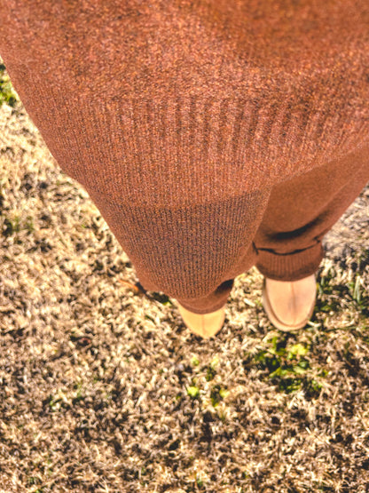 Brown pants on a person standing on grass with light brown shoes