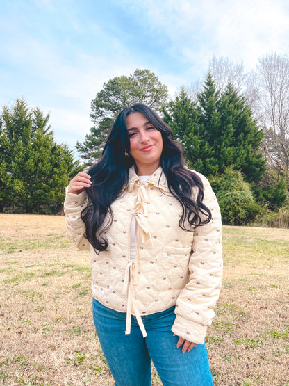 Cream quilted jacket with bow ties down the front, peter pan collar with ruffles, stylish and warm, perfect for chilly weather.