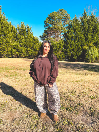 Women's brown fleece pullover with leopard print pants, perfect for cozy casual outfits. Cheetah pants paired with brown long sleeve top.