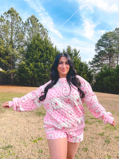 Cozy pink floral quilted loungewear outfit featuring a sweatshirt and shorts, perfect for casual comfort.