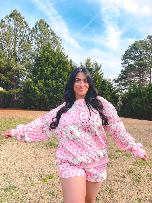 Cozy pink floral quilted loungewear outfit featuring a sweatshirt and shorts, perfect for casual comfort.