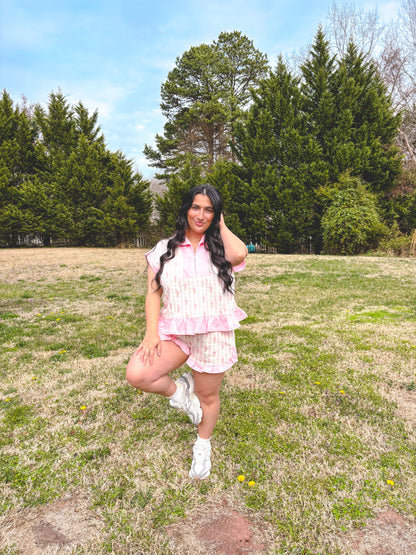 Woman posing in a field with trees in the background